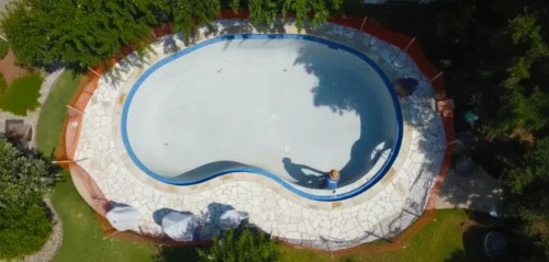 New waterline tile, coping, and decking are installed with precision, setting the tone for your design.