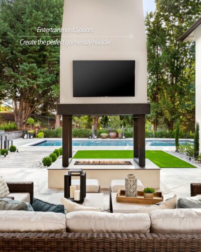 Outdoor entertainment area with fireplace, TV, and pool by custom pool builder Sanger TX.